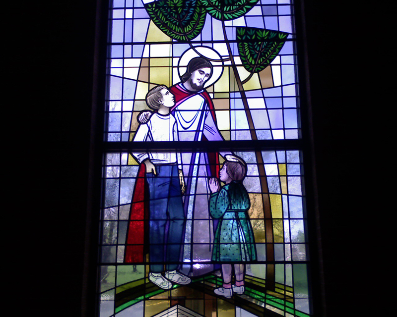 Title: Jesus Welcomes the Children; Date: 20th century; Object/Function: Stained glass; Scripture: Mark 10:2-16